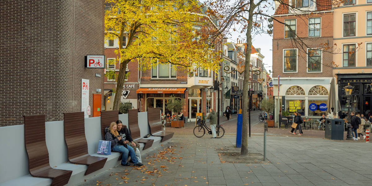 Link naar foto in Flickr: meisjes zitten op een bankje op het Stadhuisplein.