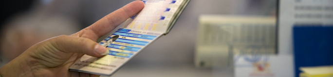 English header emigration Hand holding passport